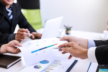 Businessman present graph financial information at the meeting.