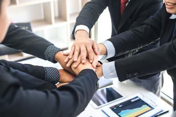 A group of business people working together as a team represents the readiness of work.