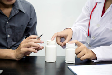 Female doctor explained about the drug intake to the patient.