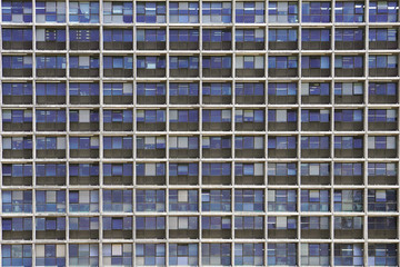 Glass grey and blue square Windows of modern city business building skyscraper. Glass balconies in the building. Modern apartment buildings in new neighborhood. Windows of a building, texture.