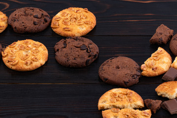 Chocolate cookies on wooden table. Homemade food on wooden background