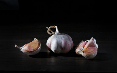 garlic with cloves isolated on black background