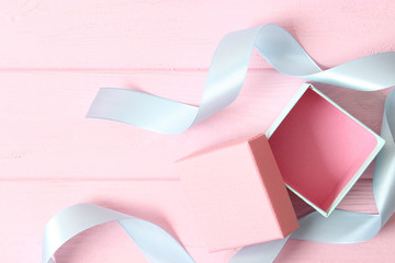 Open gift box on a colored background top view.