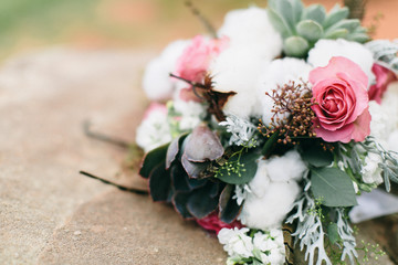 Modern flower wedding boutique with cotton, pink roses, and succulents, dessert wedding, stone background