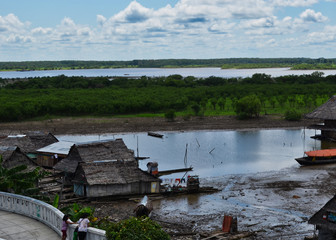 Mother and Children Looking Over Rail at Amazon Houseboats in Iquitos Peru