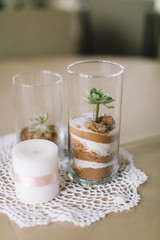 modern wedding table decoration, sand in glass vase, succulent, white pillar candle, lace