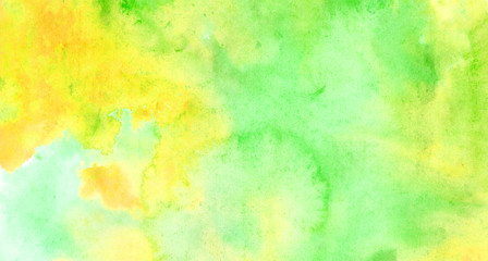 Beautiful abstract smudges of yellow green and aqua colors in hand painted watercolor background design