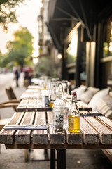 Cafe outdoor table setting with glasses and condiments