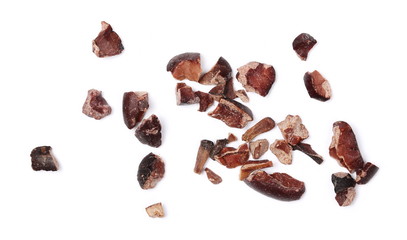 Macro chopped cocoa pile isolated on white background, top view
