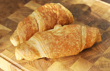tasty croissants on wooden table