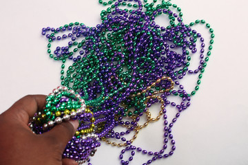 Mardi Gras beads on a white back ground