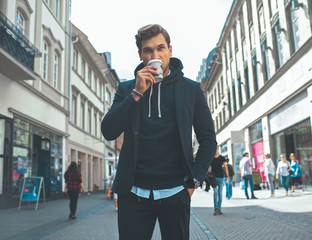 Young Adult Handsome Attractive Stylish Businessman Take a Break and Drink Coffee on the Street