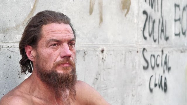 Down-and-out person on the street. Real person with no fixed abode, homeless man