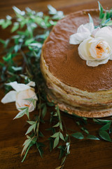 stacked crepe wedding cake decorated with peony flowers and greenery, breakfast for dinner wedding reception 
