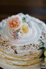 iced crepe wedding cake decorated with peony flowers and greenery, breakfast for dinner wedding reception 