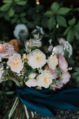 Obraz na płótnie Canvas White, pink, and peach peony flower wedding bouquet with blue silk ribbon, modern wedding flowers