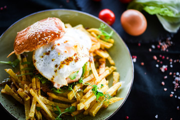home made chicken burger with fried egg & french fries