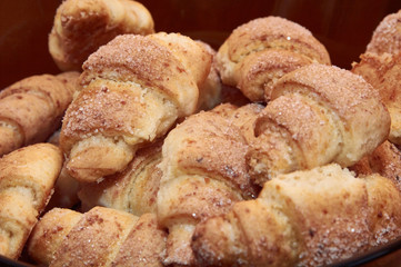 freshly baked croissants on a brown wooden table