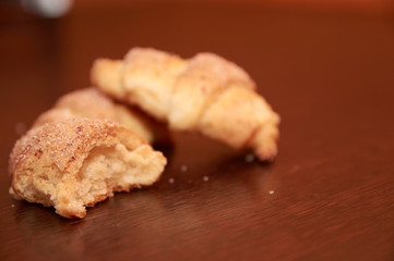 freshly baked croissants on a brown wooden table