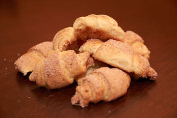 freshly baked croissants on a brown wooden table