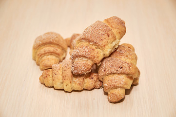 freshly baked croissants on a light wooden table