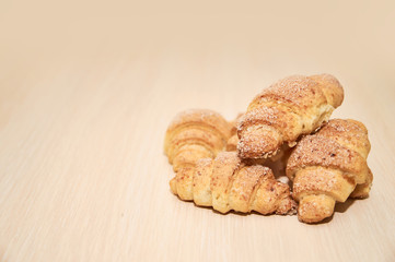 freshly baked croissants on a light wooden table