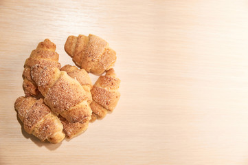 freshly baked croissants on a light wooden table