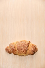 freshly baked croissants on a light wooden table