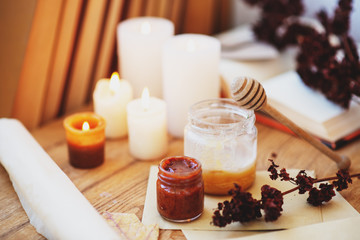  homeliness, hygge, candles, old books, diary and dried flowers on a wooden background, vintage