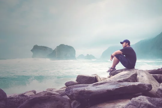 Asian young man enjoys a Papuma beach view