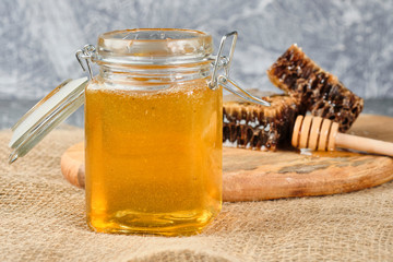 honeycomb with honey on a wooden Board, with a spoon of honey, selective focus