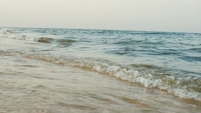 Slow motion of waves crashing at sunset, concept summer vacation and natural beauty