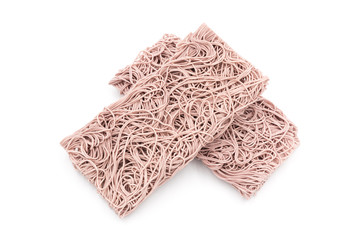Three stacked rectangular dry Purple noodles are the staple food in China on a white background.