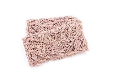 Three stacked rectangular dry Purple noodles are the staple food in China on a white background.