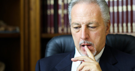 Portrait of a thoughtful manager in his office