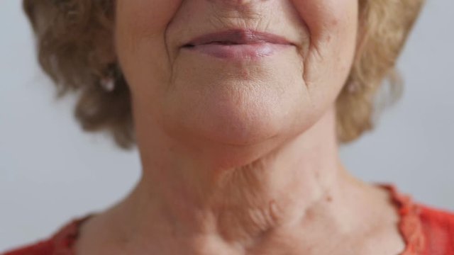 half face of an elderly happy woman, grandmother smiling, concept positive people in age