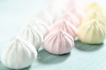 Fototapeta na wymiar Colored sweet meringues. Dessert background.
