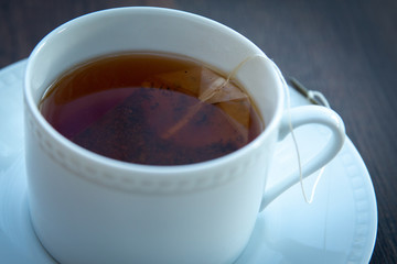 cup and saucer full of hot tea