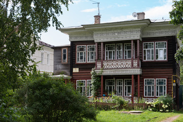 Fototapeta na wymiar Vorobyov's wooden house with carved windows and balcony. Vologda, Russia