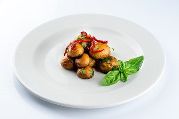 fried champignon mushrooms on a light background