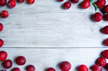 Naklejka na ściany i meble background with plum berries light wood texture