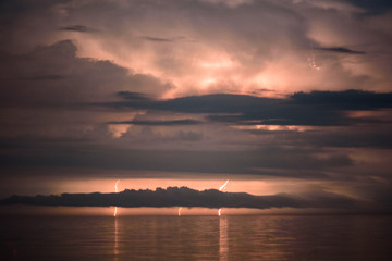 Fototapeta na wymiar Beautiful summer storm over Black Sea - dramatic scenery, lightning strikes, fire in the sky