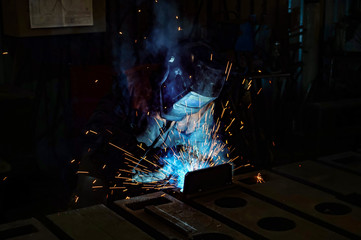 Welder at work in a workshop for the manufacture of metal structures.