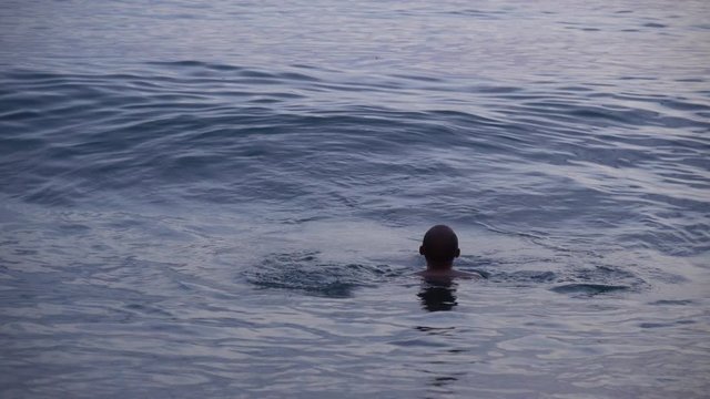 Man swimming in a sea on Kvariati beach. Georgia.