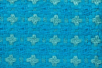 Fototapeta premium Background in the form of material from wool blue and green with a pattern, top view