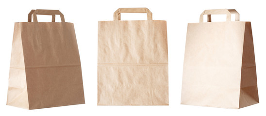 Set of new empty blank paper bag with handles without inscriptions and logos. Made from brown kraft...