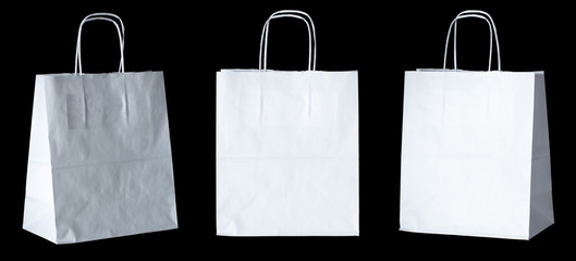 Set of new empty blank paper bag with handles without inscriptions and logos. Made from white kraft...