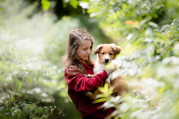 Teenage girl with cute bordertoller mix breed puppy