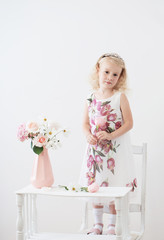 beautiful little blonde girls with  flowers on white background