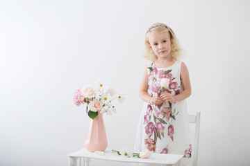 beautiful little blonde girls with  flowers on white background
